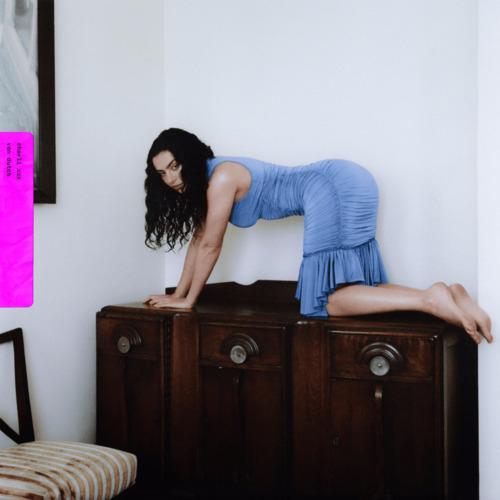 The single cover for Von Dutch. Featuring Charli wearing a baby blue dress atop a wooden dresser on her hands and knees.